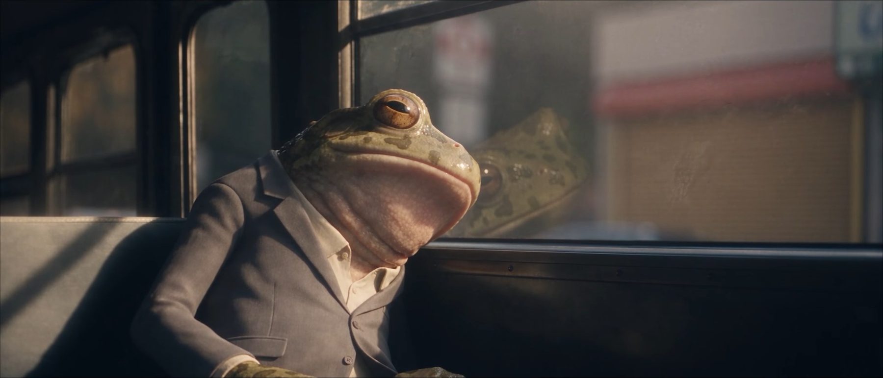 Full Time — the frog in a suit, slumped on the sofa
