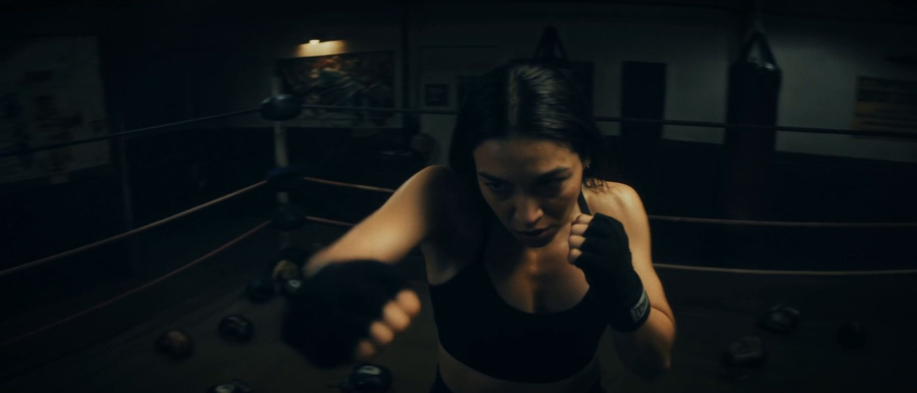A young woman running, phone to her ear, fear on her face