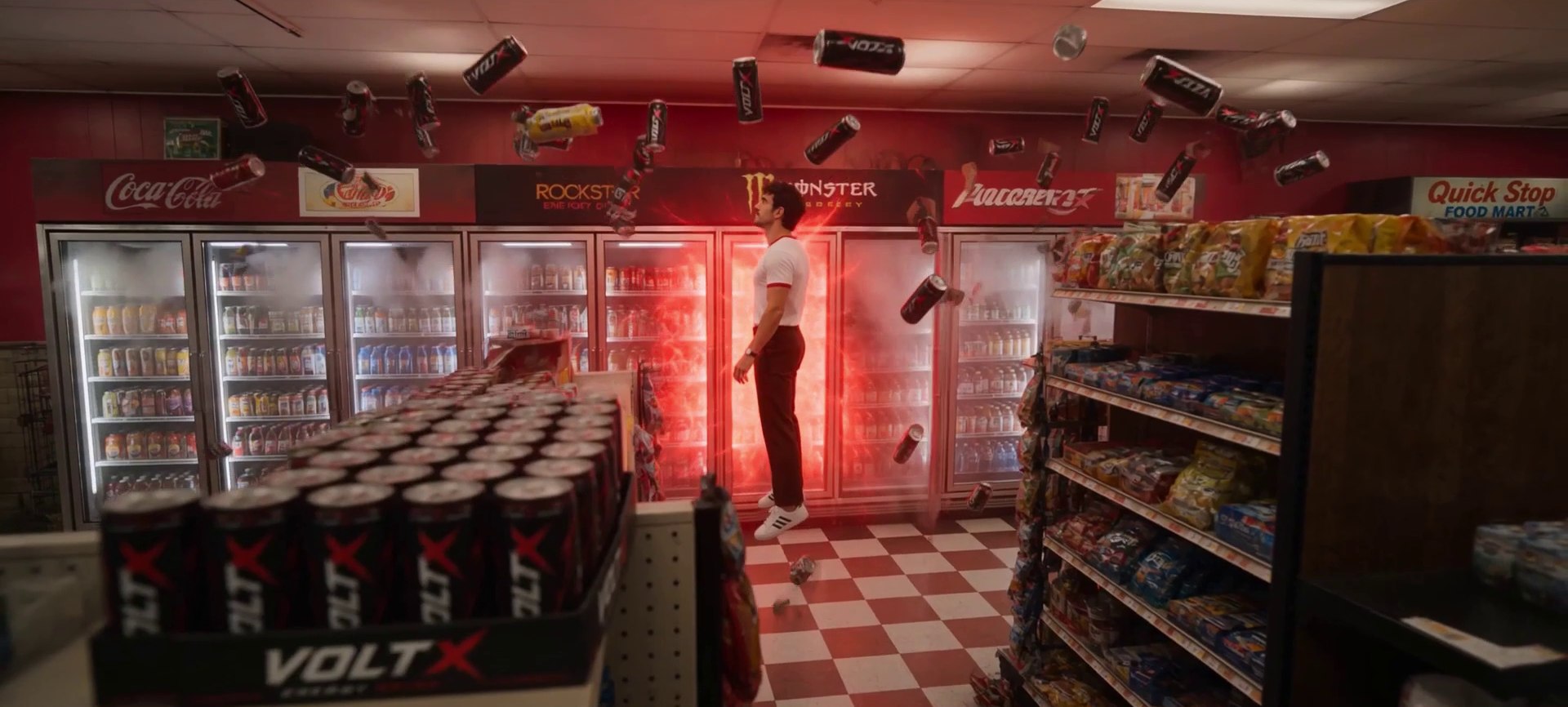A man levitates in a convenience store as VOLT X cans and red energy erupt around him from the drinks cooler